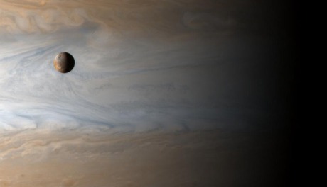 there are 350,000 kilometers - roughly 2.5 Jupiters - between Io and Jupiter's clouds. Io is about the size of our own moon (NASA/JPL/University of Arizona)